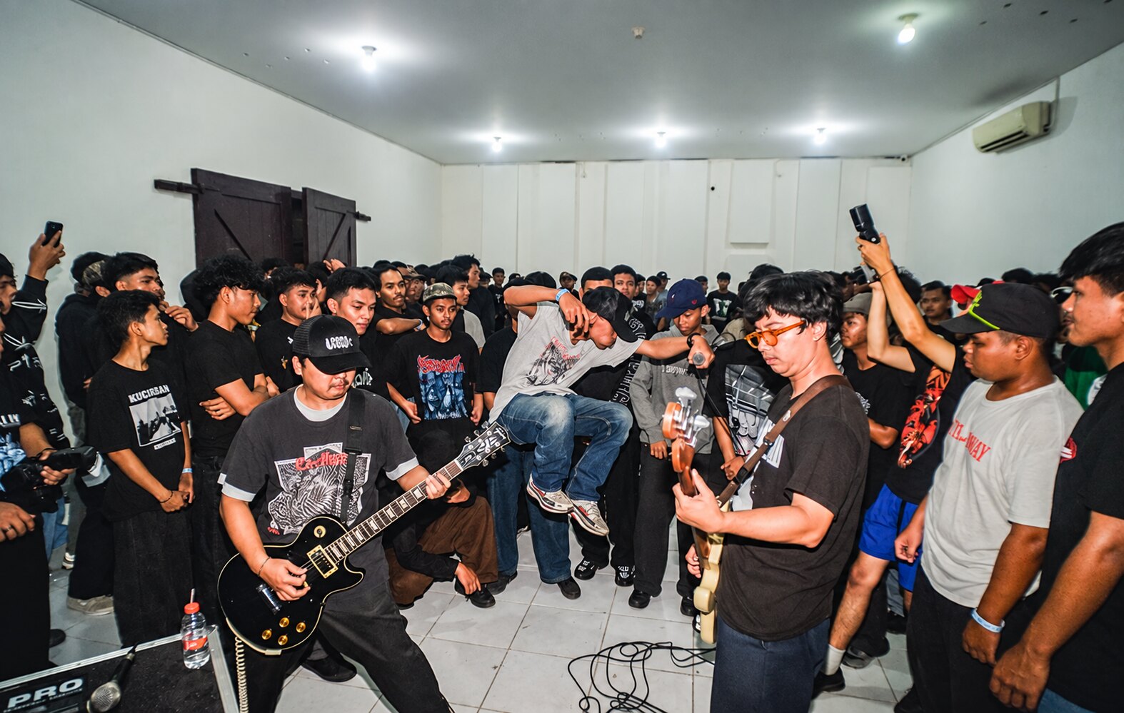 Audience and band at a hardcore show in Aula Timur Lokananta